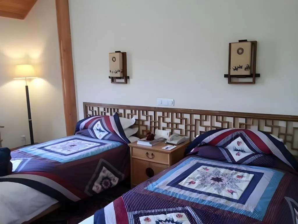 Bed in The Silk Road Dunhuang Hotel