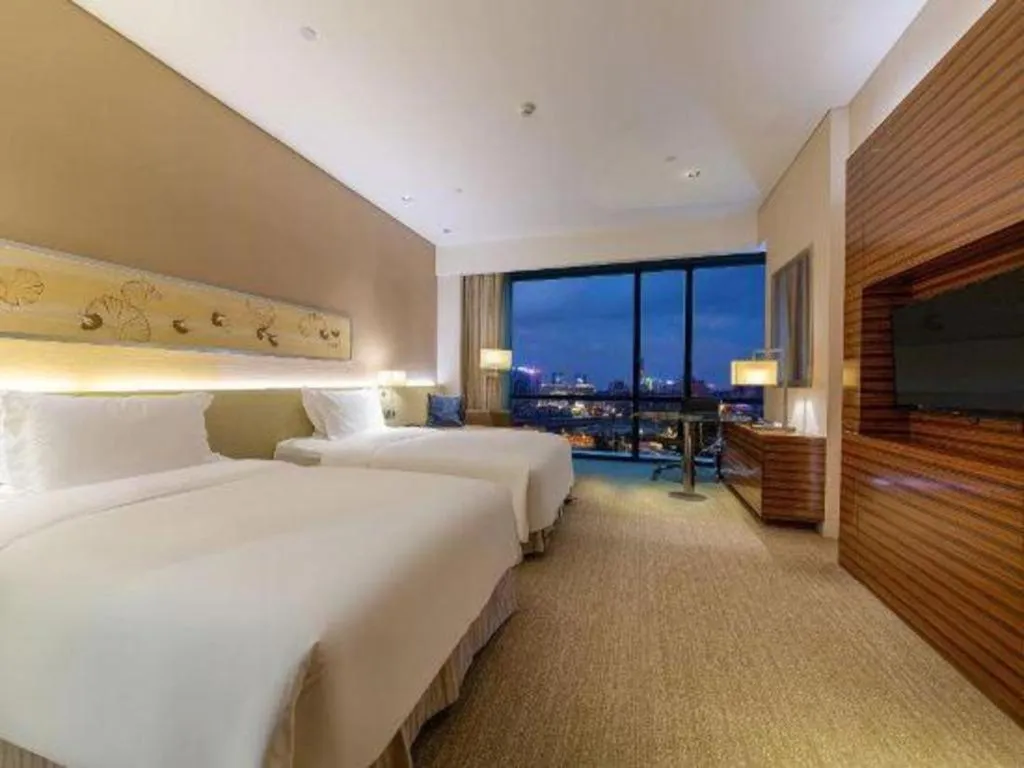 Bed in New World Guiyang Hotel