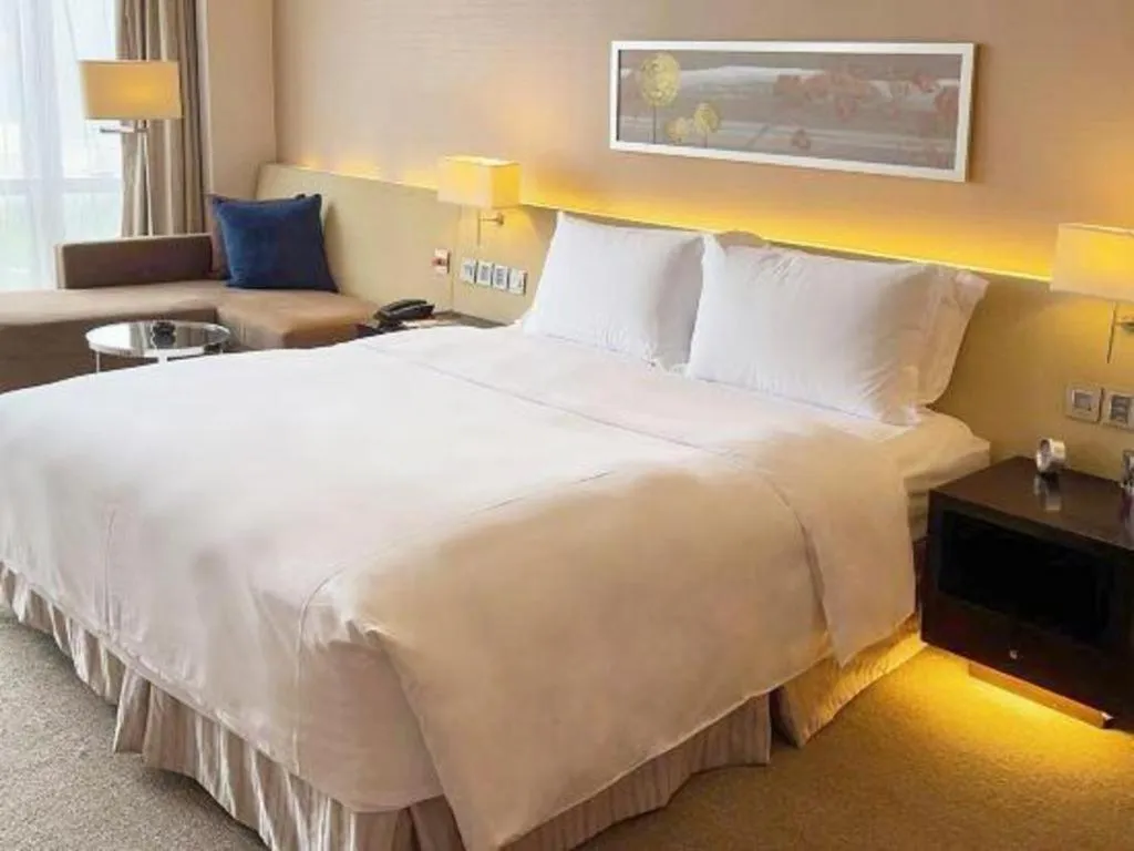 Bed in New World Guiyang Hotel