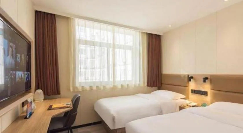 Bed in GreenTree Inn West Railway Station North Square Hotel