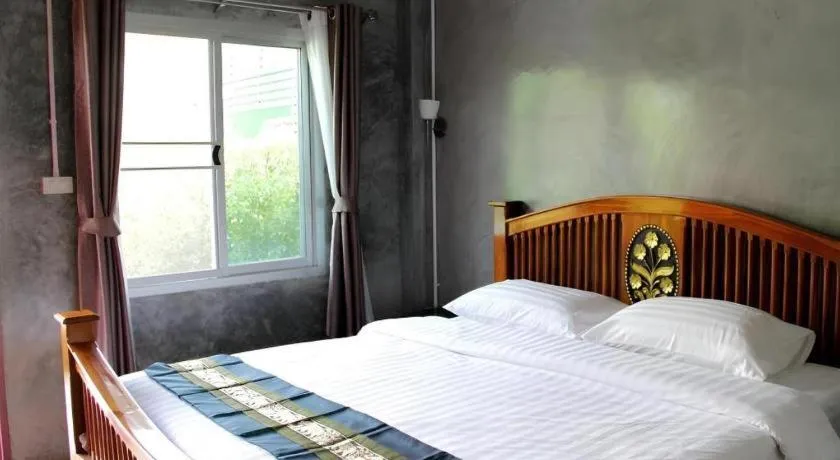 Bed in Rommai Rimnaam Resort