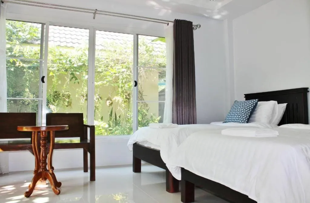 Bed in Rommai Rimnaam Resort