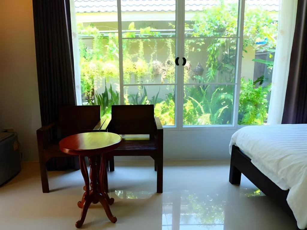 Bed in Rommai Rimnaam Resort