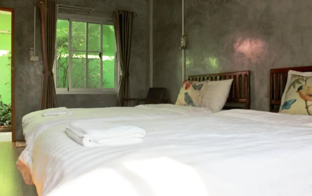 Bed in Rommai Rimnaam Resort