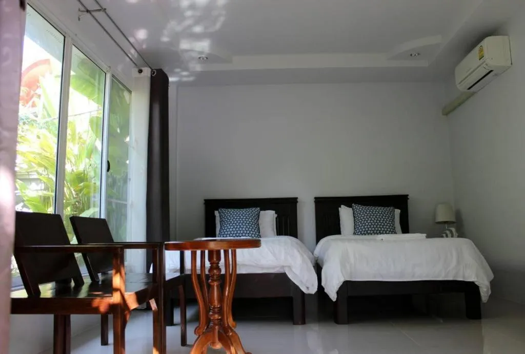 Bed in Rommai Rimnaam Resort