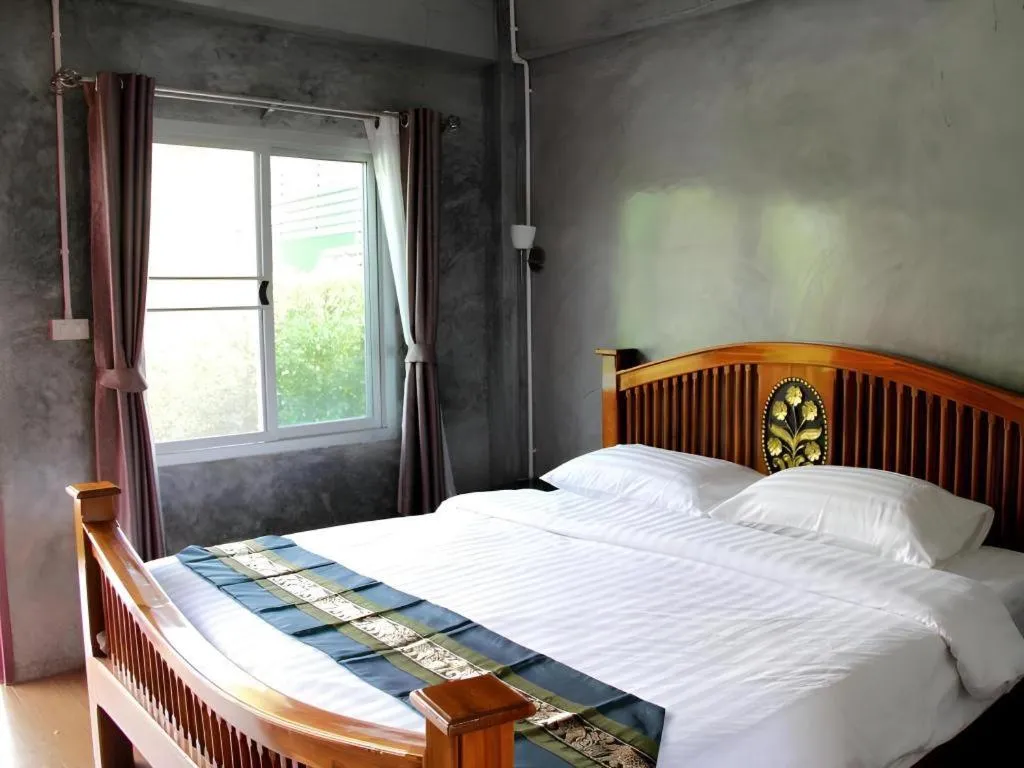 Bed in Rommai Rimnaam Resort