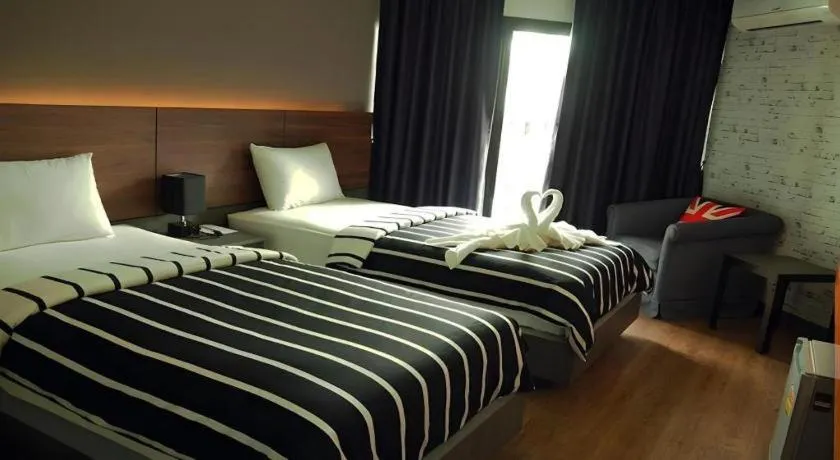 Bed in The Loft Seaside Sriracha Hotel