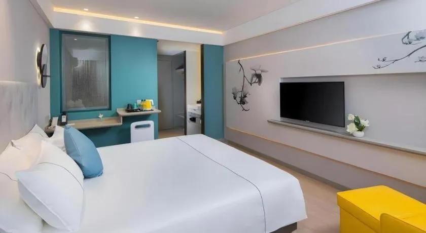 Bed in Magnotel Hotel Shanghai Jinjiang Park Branch