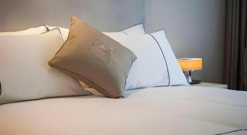 Bed in Magnotel Hotel Shanghai Jinjiang Park Branch