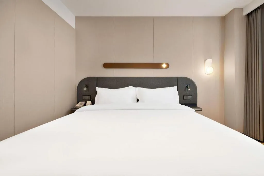 Bed in Jinjiang Inn Beijing Capital International Airport New Expo Metro Station