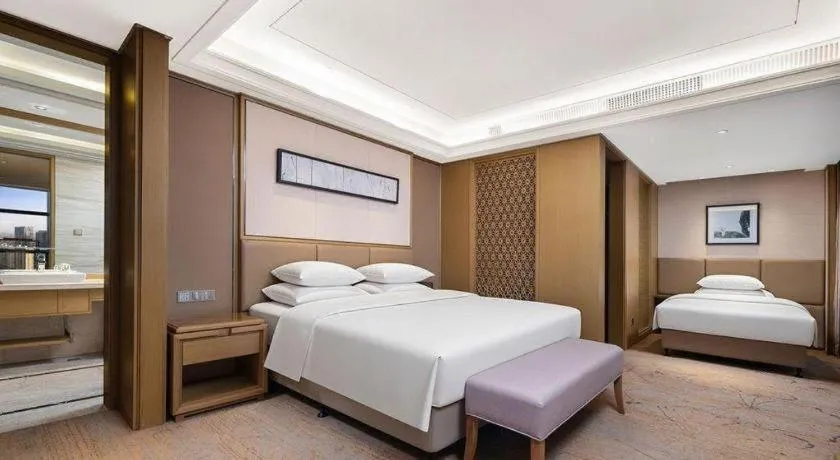 Bed in New Century Grand Hotel Hangzhou Zheshang