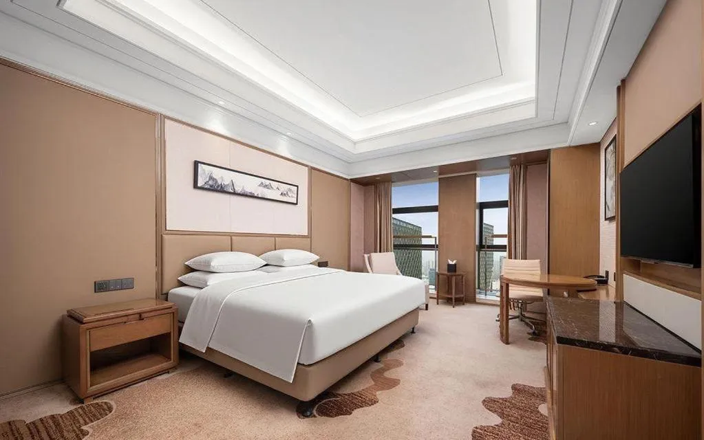 Bed in New Century Grand Hotel Hangzhou Zheshang