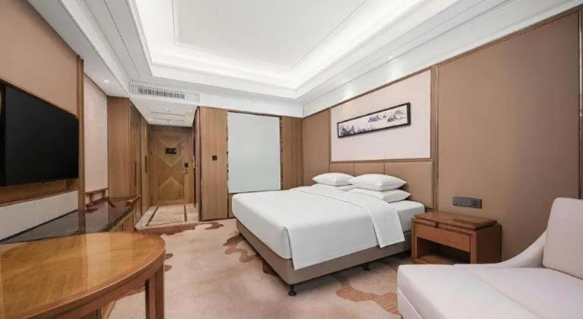 Bed in New Century Grand Hotel Hangzhou Zheshang