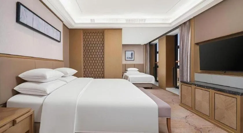 Bed in New Century Grand Hotel Hangzhou Zheshang