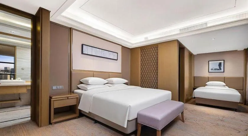 Bed in New Century Grand Hotel Hangzhou Zheshang