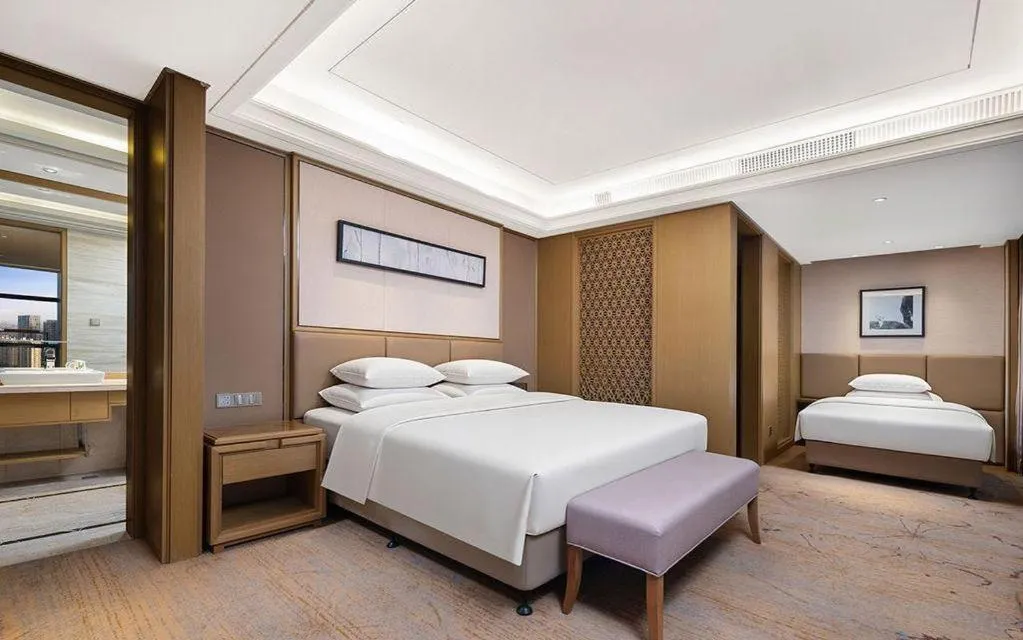 Bed in New Century Grand Hotel Hangzhou Zheshang