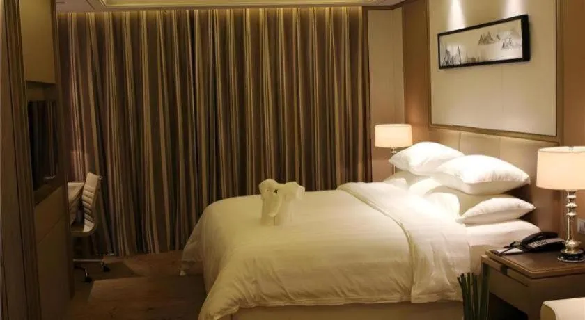 Bed in New Century Grand Hotel Hangzhou Zheshang