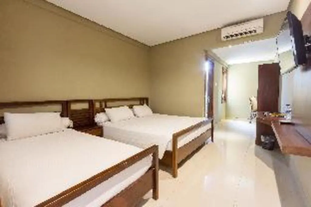 Bed in Hotel Adilla Syariah Ambarukmo