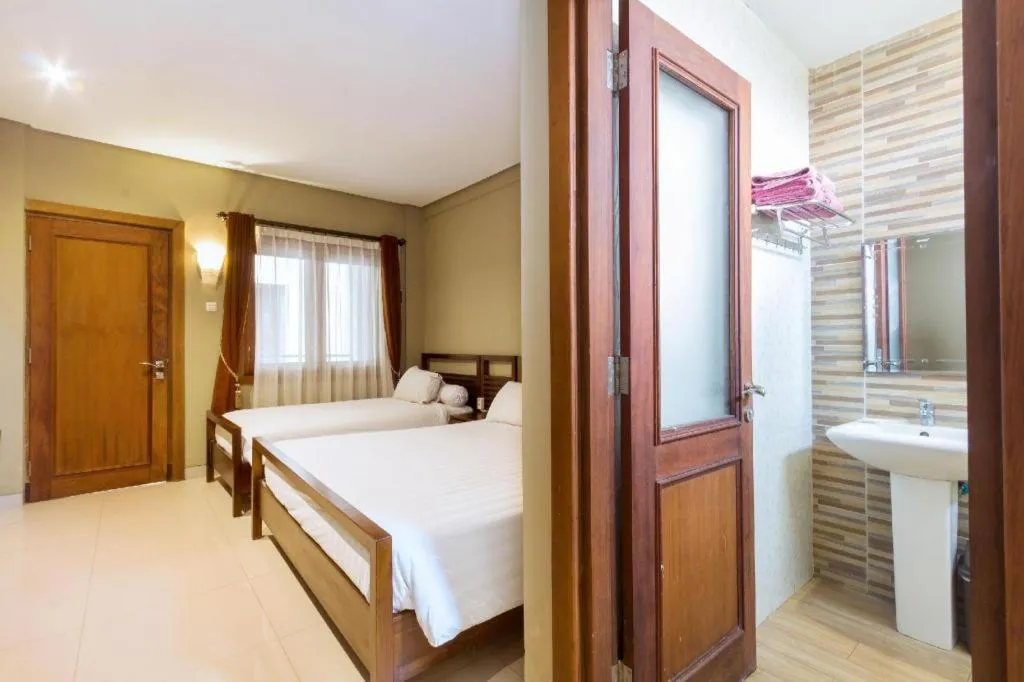 Bed in Hotel Adilla Syariah Ambarukmo