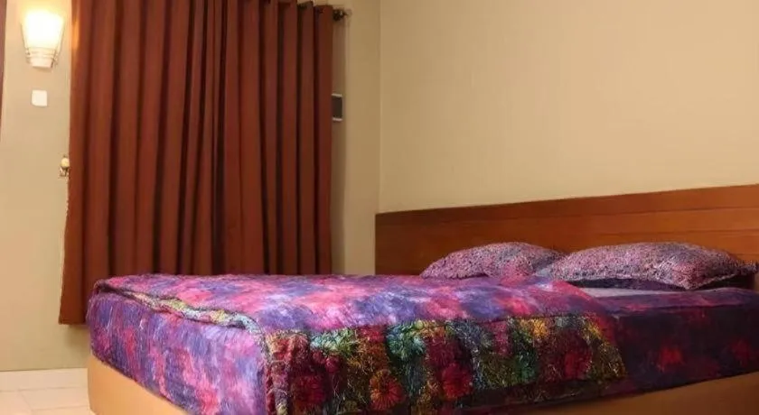 Bed in Hotel Adilla Syariah Ambarukmo