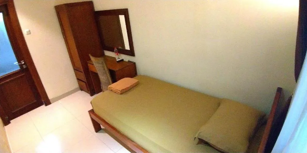 Bed in Hotel Adilla Syariah Ambarukmo