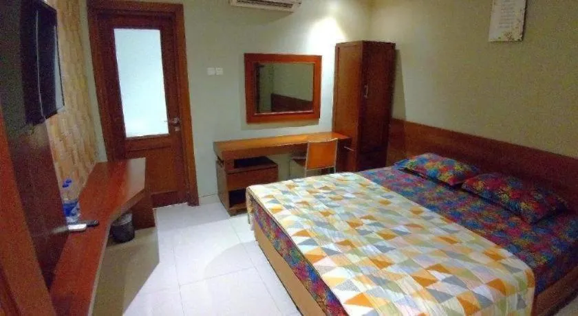 Bed in Hotel Adilla Syariah Ambarukmo