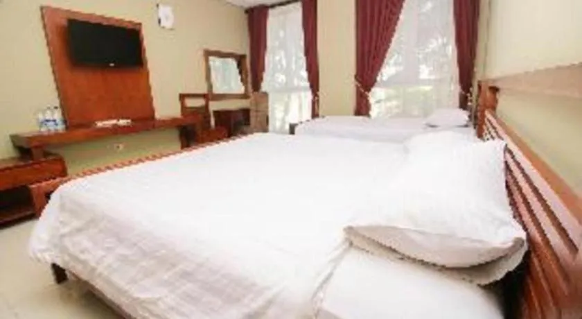 Bed in Hotel Adilla Syariah Ambarukmo