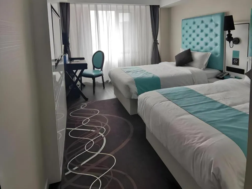 Bed in Xana Hotelle Beijing Qianmen Footbridge Metro Station