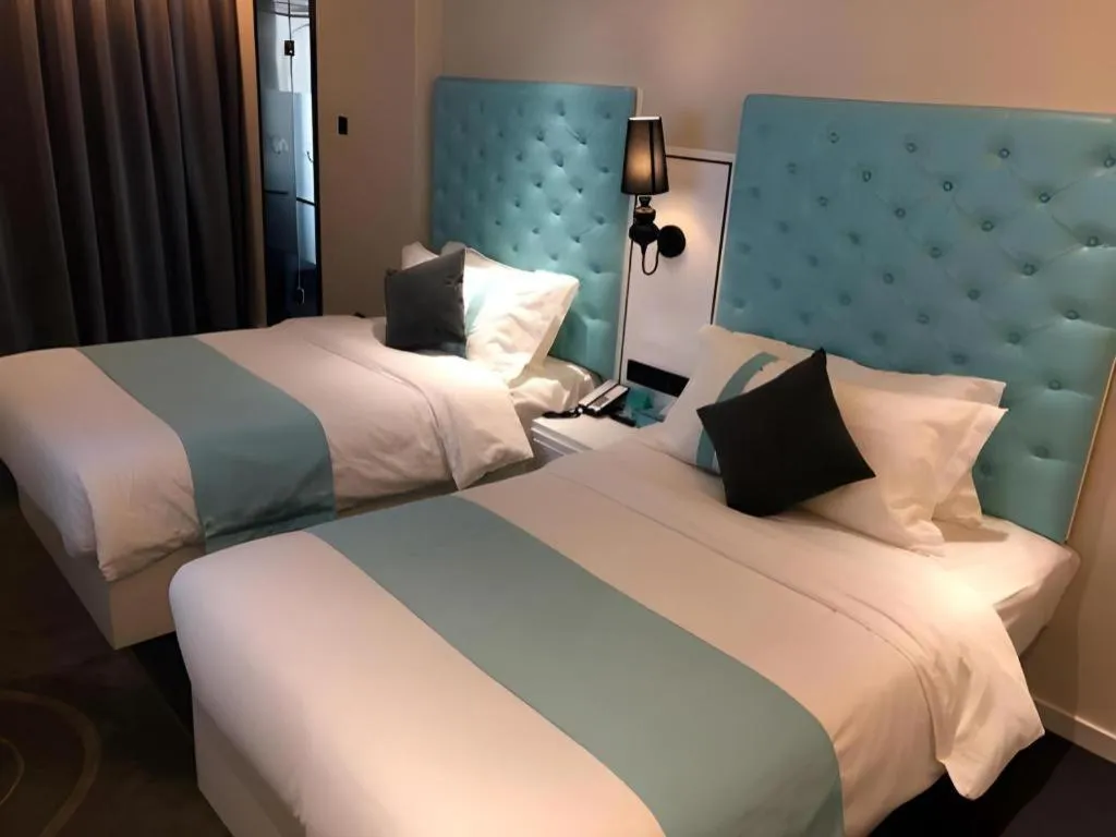 Bed in Xana Hotelle Beijing Qianmen Footbridge Metro Station