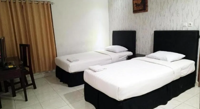 Bed in The Garden Hotel