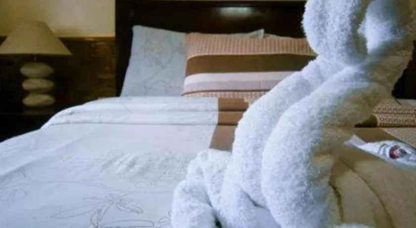 Bed in Coucou Bar Hotel and Restaurant