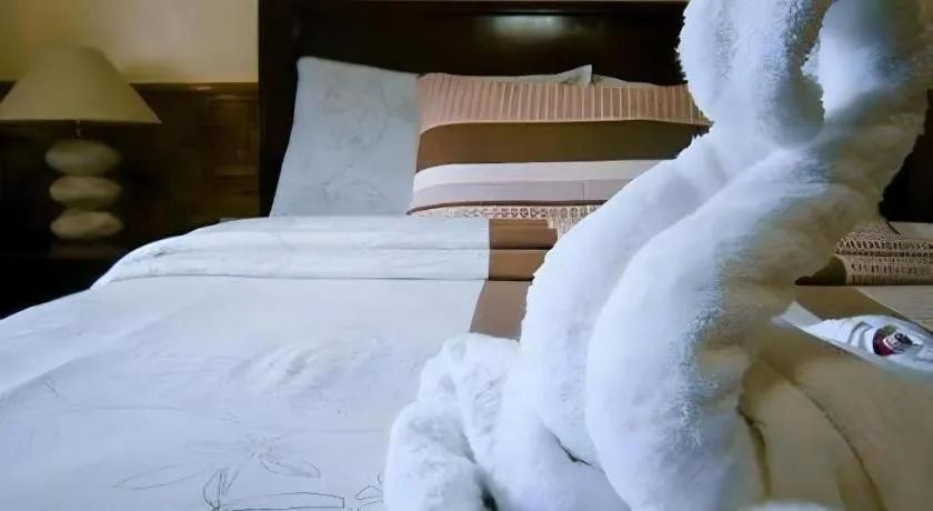 Bed in Coucou Bar Hotel and Restaurant