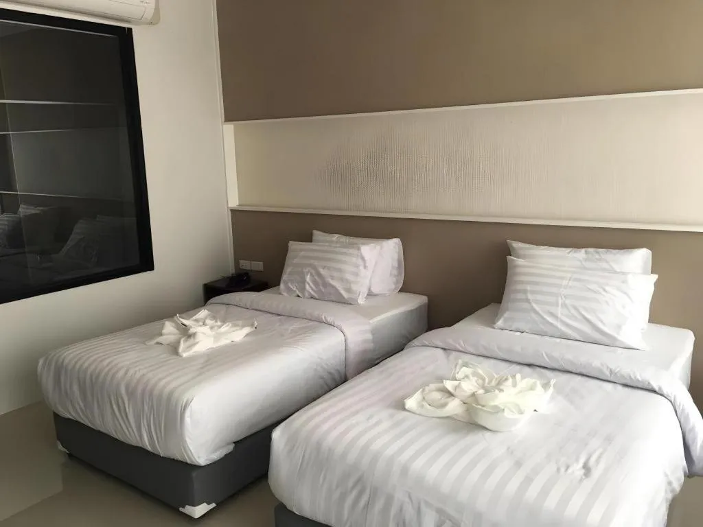 Bed in S-Tawan Hotel & Convention