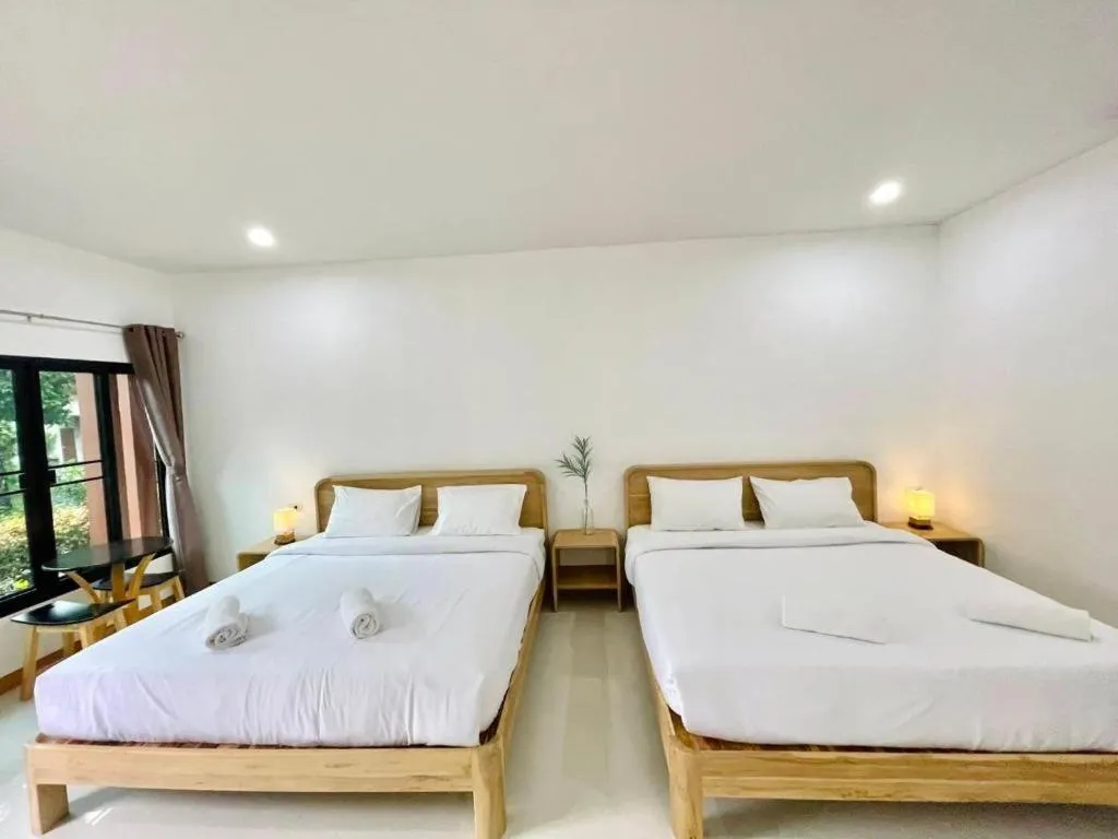 Bed in Baan Klang Suan Resort