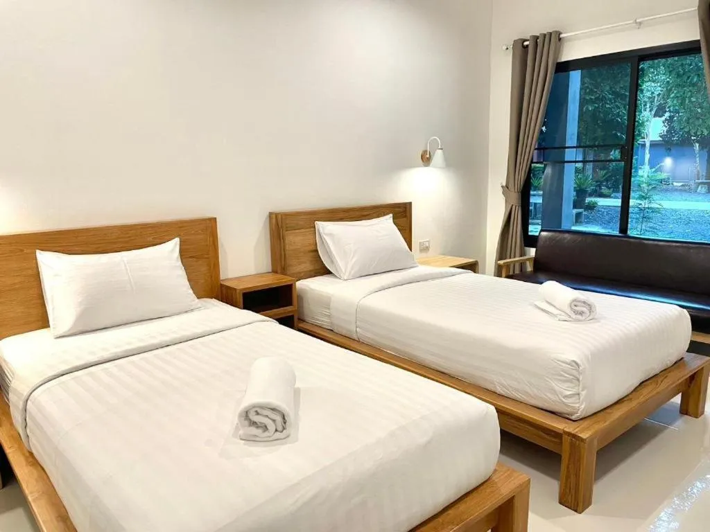 Bed in Baan Klang Suan Resort