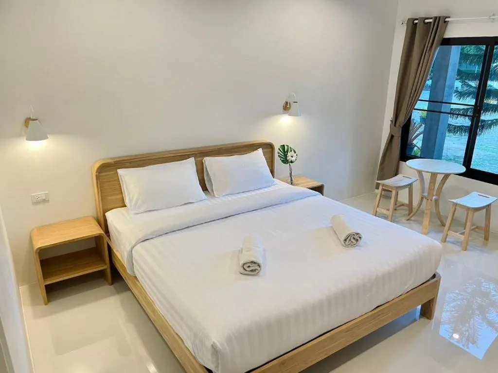 Bed in Baan Klang Suan Resort