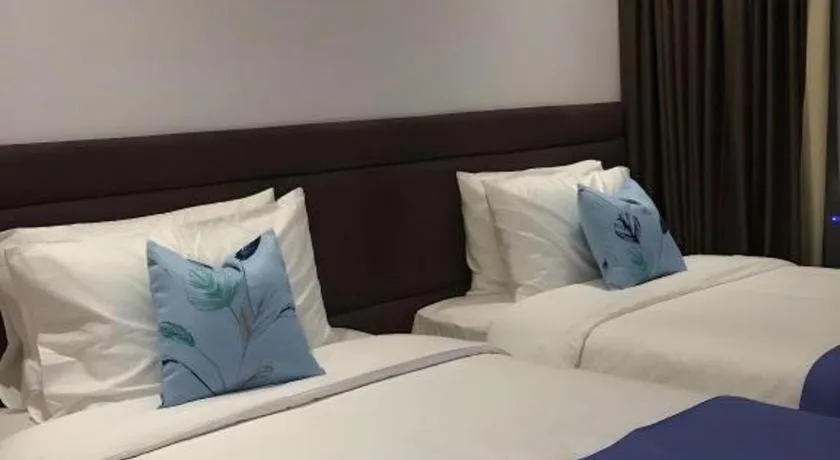 Bed in White Breeze Palawan Boutique Hotel