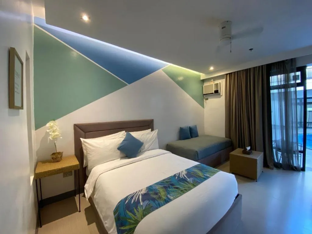 Bed in White Breeze Palawan Boutique Hotel
