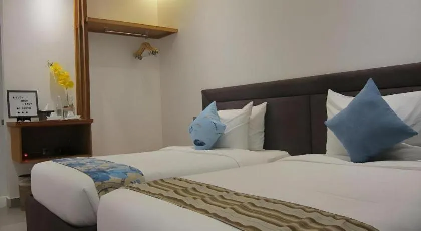 Bed in White Breeze Palawan Boutique Hotel