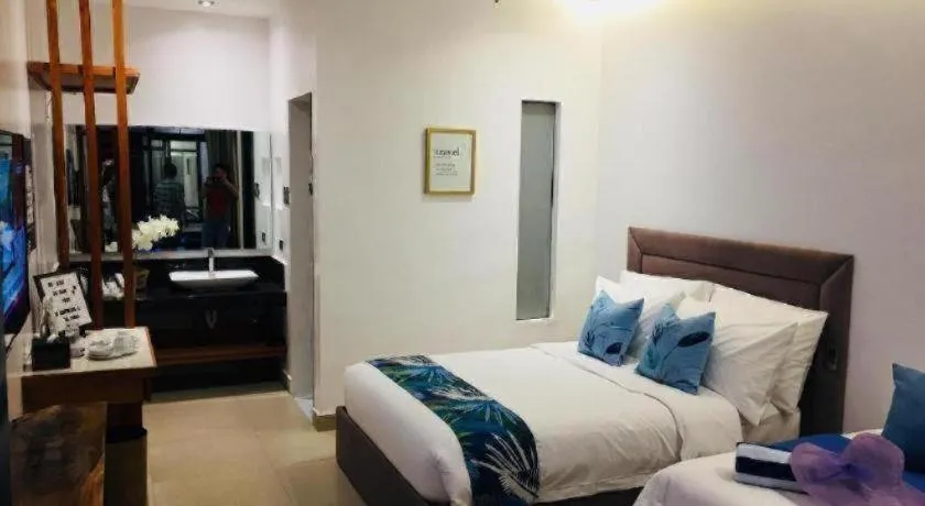 Bed in White Breeze Palawan Boutique Hotel