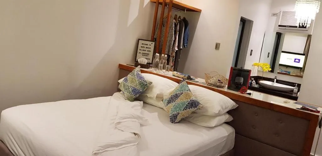 Bed in White Breeze Palawan Boutique Hotel