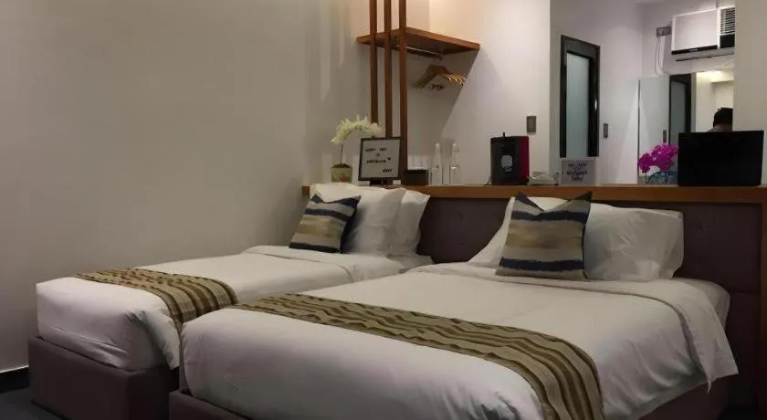 Bed in White Breeze Palawan Boutique Hotel