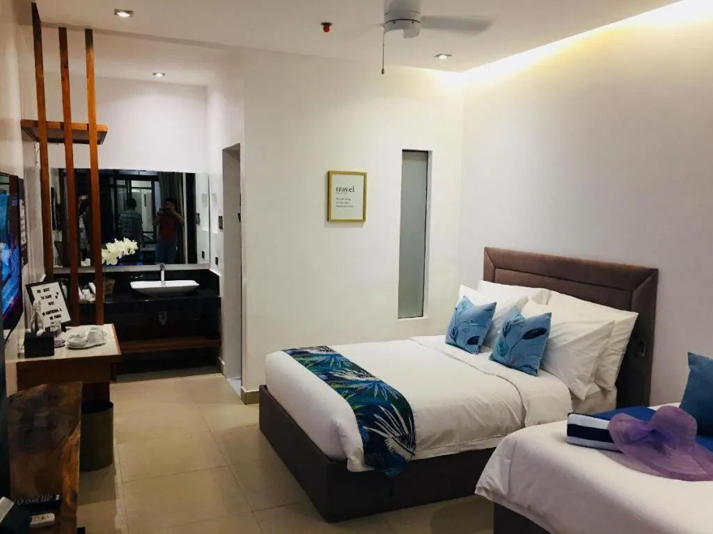 Bed in White Breeze Palawan Boutique Hotel