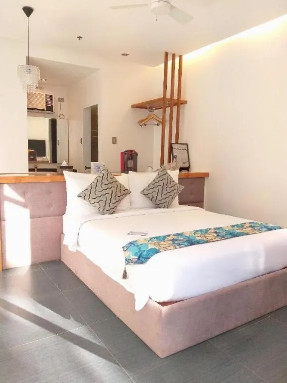 Bed in White Breeze Palawan Boutique Hotel