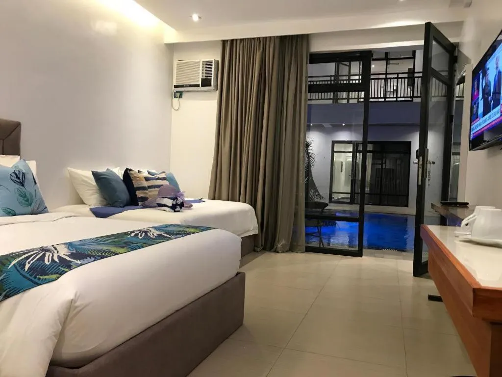 Bed in White Breeze Palawan Boutique Hotel