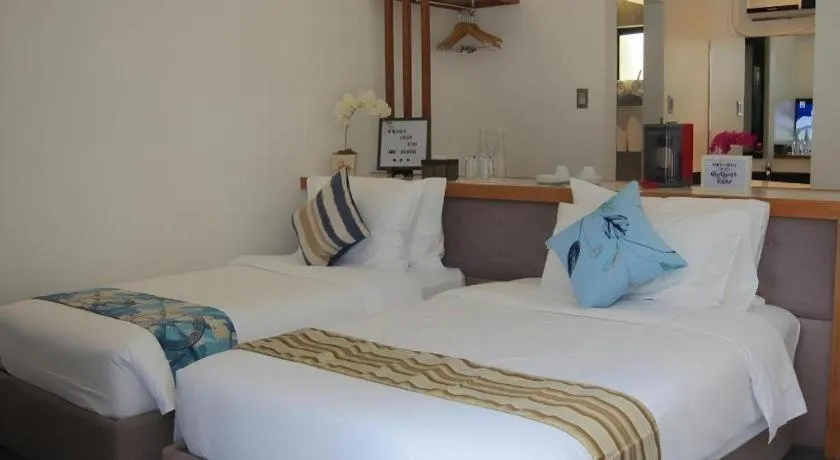 Bed in White Breeze Palawan Boutique Hotel