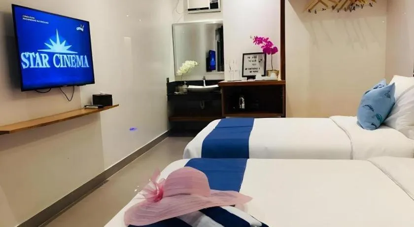 Bed in White Breeze Palawan Boutique Hotel