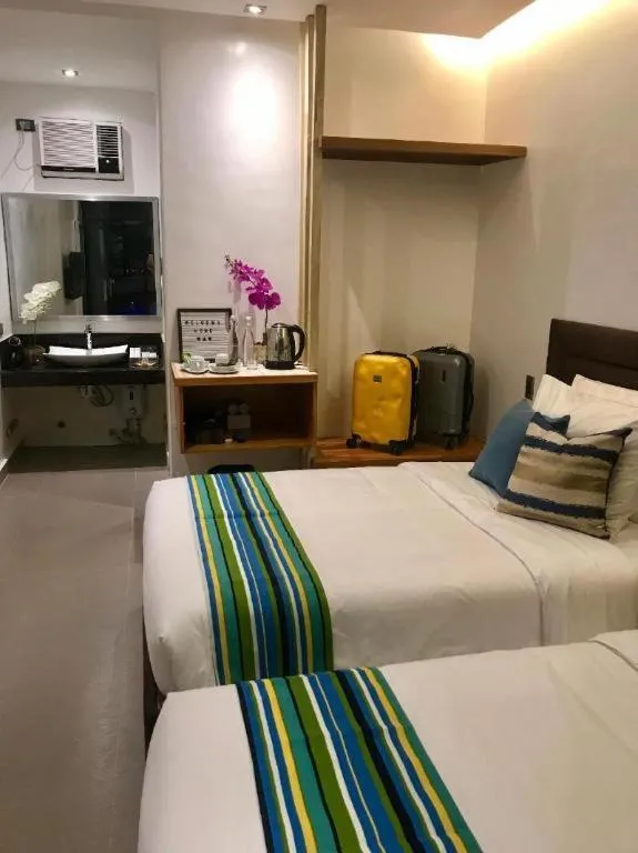 Bed in White Breeze Palawan Boutique Hotel