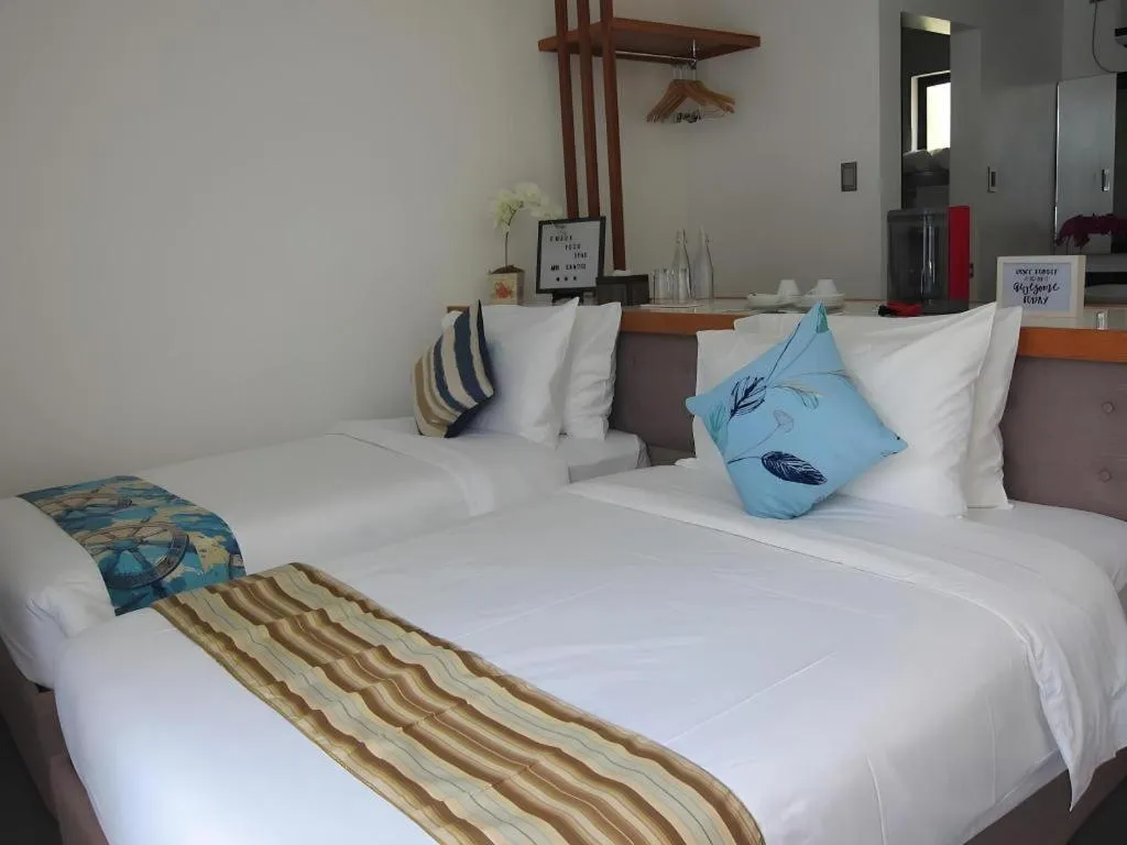 Bed in White Breeze Palawan Boutique Hotel
