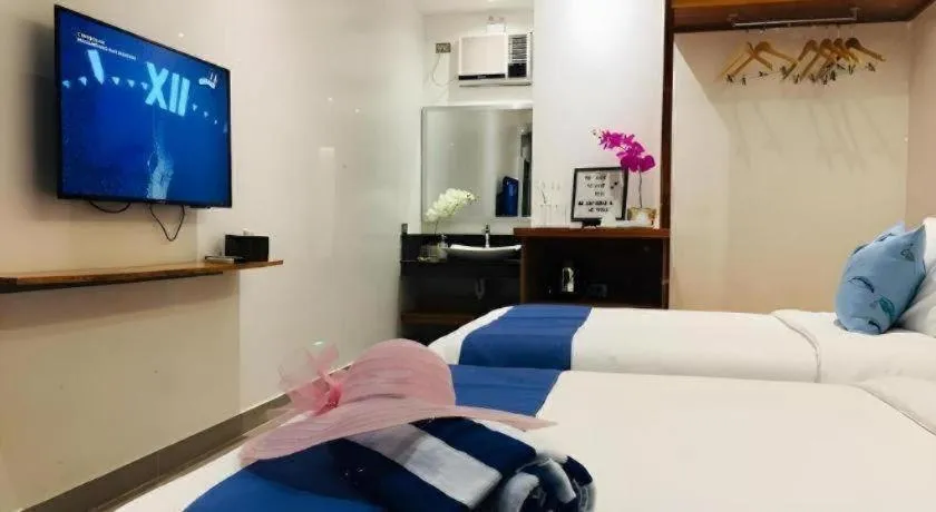 Bed in White Breeze Palawan Boutique Hotel